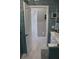 Bathroom with tiled walls, modern fixtures, and open doorway to a hallway at 24197 Treasure Island Blvd., Punta Gorda, FL 33955