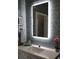 Modern bathroom features stylish blue subway tile and an illuminated LED mirror at 24197 Treasure Island Blvd., Punta Gorda, FL 33955