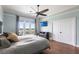 Relaxing bedroom with wood floors, a ceiling fan, balcony access, and a large closet for storage at 24197 Treasure Island Blvd., Punta Gorda, FL 33955