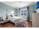 Well-lit bedroom with pale blue walls and an area rug over hardwood floors at 24197 Treasure Island Blvd., Punta Gorda, FL 33955