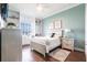 Cozy bedroom featuring built-in shelving, window seat, and light wood floors at 24197 Treasure Island Blvd., Punta Gorda, FL 33955