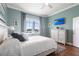 A serene bedroom offers a view of the outdoors, complemented by a ceiling fan at 24197 Treasure Island Blvd., Punta Gorda, FL 33955