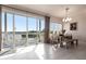 Bright dining area with a table set next to a large window offers lovely outdoor views and access to the balcony at 24197 Treasure Island Blvd., Punta Gorda, FL 33955