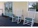 Charming front porch with rocking chairs, aqua cushions and french doors at 24197 Treasure Island Blvd., Punta Gorda, FL 33955