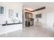 Hallway area featuring a bar with wine cooler, wood beamed ceilings, decorative lighting, and neutral walls at 24197 Treasure Island Blvd., Punta Gorda, FL 33955