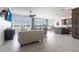 Open concept living area with hardwood floors, modern furnishings, balcony access, and a beautiful kitchen area at 24197 Treasure Island Blvd., Punta Gorda, FL 33955