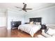 Spacious main bedroom featuring wood floors, ceiling fan, and a comfortable seating area at 24197 Treasure Island Blvd., Punta Gorda, FL 33955