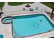 Aerial view of the in-ground pool and outdoor fireplace area in the backyard at 24197 Treasure Island Blvd., Punta Gorda, FL 33955