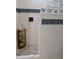 Modern walk-in shower with decorative tiles, glass block wall, and wood shelf at 24197 Treasure Island Blvd., Punta Gorda, FL 33955