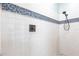 Close-up of a stylish shower with white subway tile and mosaic accents at 24197 Treasure Island Blvd., Punta Gorda, FL 33955