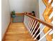 Top down shot of a wood staircase, neutral walls and a plant at the base of the steps at 24197 Treasure Island Blvd., Punta Gorda, FL 33955