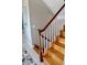 Close-up of hardwood staircase with white spindles and a curved wooden handrail at 24197 Treasure Island Blvd., Punta Gorda, FL 33955