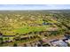 A beautiful aerial view overlooking a well-manicured golf course in a lush, green neighborhood at 2479 Trade Winds Dr, Dunedin, FL 34698