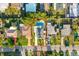 Aerial view of a single-Gathering home featuring a private pool, driveway, and well-maintained landscaping at 2479 Trade Winds Dr, Dunedin, FL 34698