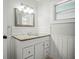 Updated bathroom featuring granite counters, white cabinets, and modern fixtures at 2479 Trade Winds Dr, Dunedin, FL 34698