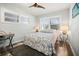 Cozy bedroom featuring two windows, a ceiling fan, and stylish furnishings at 2479 Trade Winds Dr, Dunedin, FL 34698