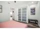 Charming bedroom features a sliding glass closet and comfortable seating area at 2479 Trade Winds Dr, Dunedin, FL 34698