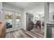 Bright kitchen boasts stainless steel refrigerator, wood floors, and french doors leading to the pool at 2479 Trade Winds Dr, Dunedin, FL 34698