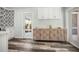 Cozy kitchen with stylish wood floors, decorative wall cabinet, and access to the backyard at 2479 Trade Winds Dr, Dunedin, FL 34698
