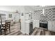 Modern kitchen with stainless steel appliances, geometric tile backsplash, and open layout at 2479 Trade Winds Dr, Dunedin, FL 34698