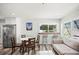Inviting living room with a dining area, modern furnishings, and large windows offering plenty of natural light at 2479 Trade Winds Dr, Dunedin, FL 34698