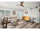 Relaxing living room with hardwood floors, a comfortable sofa, and a decorative barn door adding character at 2479 Trade Winds Dr, Dunedin, FL 34698