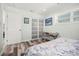 Comfortable bedroom with a workspace featuring sliding closet doors and stylish decor at 2479 Trade Winds Dr, Dunedin, FL 34698