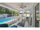 Enclosed patio with dining table and a view of a sparkling pool and fenced-in backyard at 2479 Trade Winds Dr, Dunedin, FL 34698