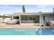 Inviting pool area with outdoor seating and a covered patio perfect for relaxation at 2479 Trade Winds Dr, Dunedin, FL 34698