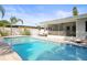 Sparkling pool with screened lanai and outdoor dining area at 2479 Trade Winds Dr, Dunedin, FL 34698
