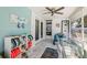 Bright sun room with tile floors, comfortable seating, and serene decor at 2479 Trade Winds Dr, Dunedin, FL 34698