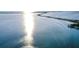 Scenic view of the ocean and causeway with shimmering reflections of the sun at 2479 Trade Winds Dr, Dunedin, FL 34698