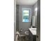 Small bathroom featuring gray tile, a window, and a shower/tub combo at 2709 S Manhattan Ave, Tampa, FL 33629