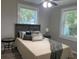Bedroom featuring two windows, a ceiling fan, and wood look flooring at 2709 S Manhattan Ave, Tampa, FL 33629