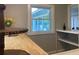 A bright counter area with a natural wood counter, a window, and a built in shelf at 2709 S Manhattan Ave, Tampa, FL 33629
