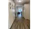 Hallway featuring white built-in cabinets, and views of a living area with wood-look floors at 2709 S Manhattan Ave, Tampa, FL 33629