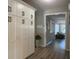 Hallway featuring white built-in cabinets, and views of a living area with wood-look floors at 2709 S Manhattan Ave, Tampa, FL 33629