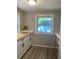 Bright kitchen showcasing white cabinets, butcher block countertops, and natural light from a large window at 2709 S Manhattan Ave, Tampa, FL 33629