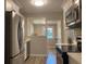 Updated kitchen with stainless steel appliances, white cabinets, and view into dining area at 2709 S Manhattan Ave, Tampa, FL 33629