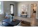 Well-decorated living room showcasing stylish furniture, neutral tones, modern art, and ample natural light at 2709 S Manhattan Ave, Tampa, FL 33629