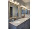 Beautiful bathroom featuring a double sink vanity with granite countertops and modern lighting at 2714 60Th Avenue W Ter # 12D, Bradenton, FL 34207