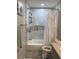 Cozy bathroom with a shower and tub combo and elegant marble-style tile walls at 2714 60Th Avenue W Ter # 12D, Bradenton, FL 34207