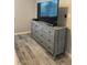 Spacious bedroom featuring a large dresser with modern finish and laminate flooring at 2714 60Th Avenue W Ter # 12D, Bradenton, FL 34207