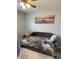 Comfortable sitting area with plush daybed and decorative throw pillows under a ceiling fan at 2714 60Th Avenue W Ter # 12D, Bradenton, FL 34207