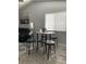Dining space features a round table and chairs complemented by natural light from the window at 2714 60Th Avenue W Ter # 12D, Bradenton, FL 34207
