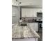 Bright kitchen with white cabinets, granite counters, stainless appliances and stylish pendant lighting at 2714 60Th Avenue W Ter # 12D, Bradenton, FL 34207