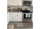 Modern kitchen showcasing stainless steel appliances, white cabinets and stylish flooring at 2714 60Th Avenue W Ter # 12D, Bradenton, FL 34207