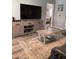 Inviting living room with stylish TV console and laminate flooring, perfect for relaxing at 2714 60Th Avenue W Ter # 12D, Bradenton, FL 34207