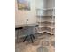 Bright office space with a modern desk, gray chair, and stylish white shelving unit at 2714 60Th Avenue W Ter # 12D, Bradenton, FL 34207
