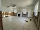 Spacious living room featuring tile floors, a fireplace, and large windows for natural light at 3207 S De Bazan Ave, St Pete Beach, FL 33706
